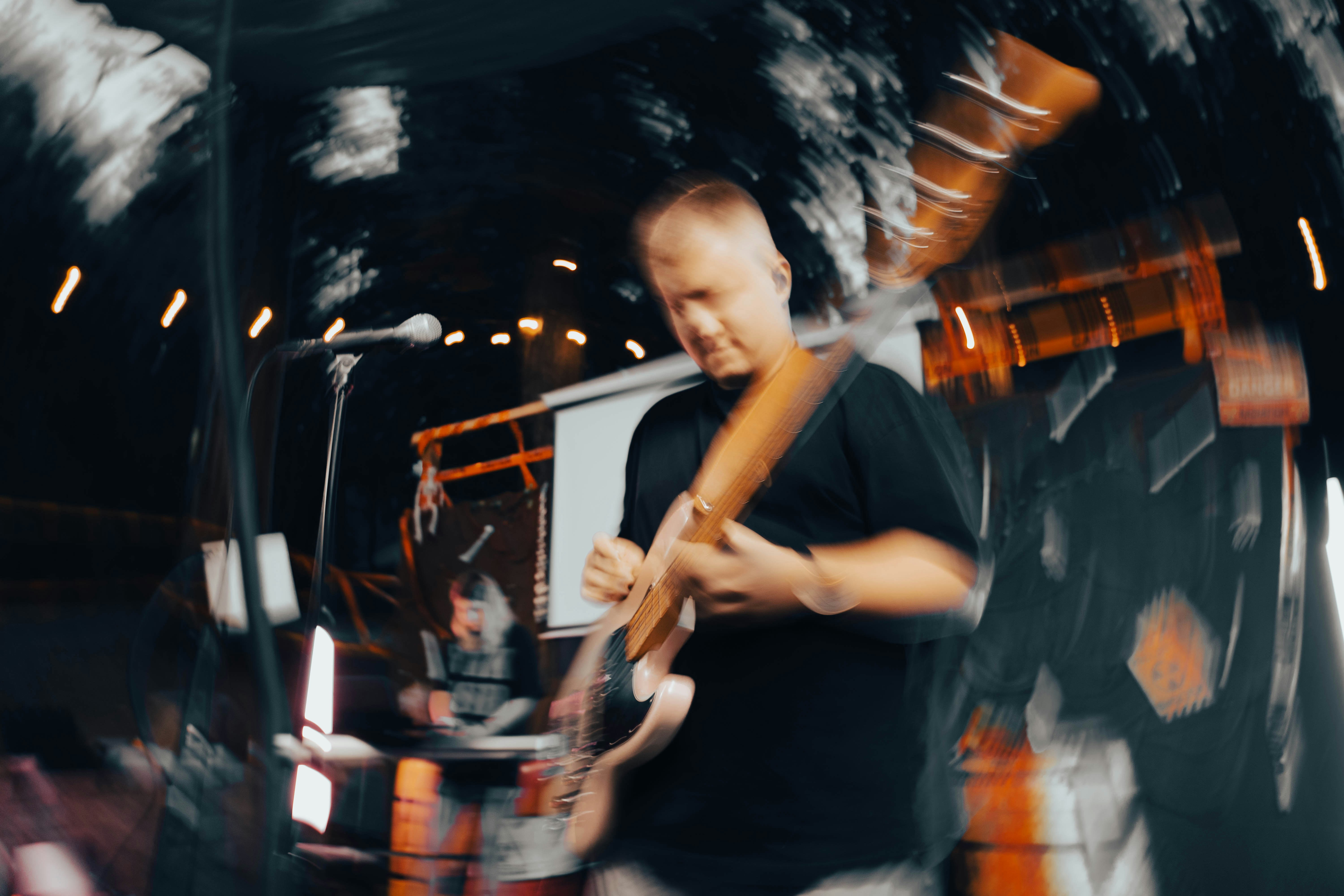 A blurry photo of a man holding a hot dog