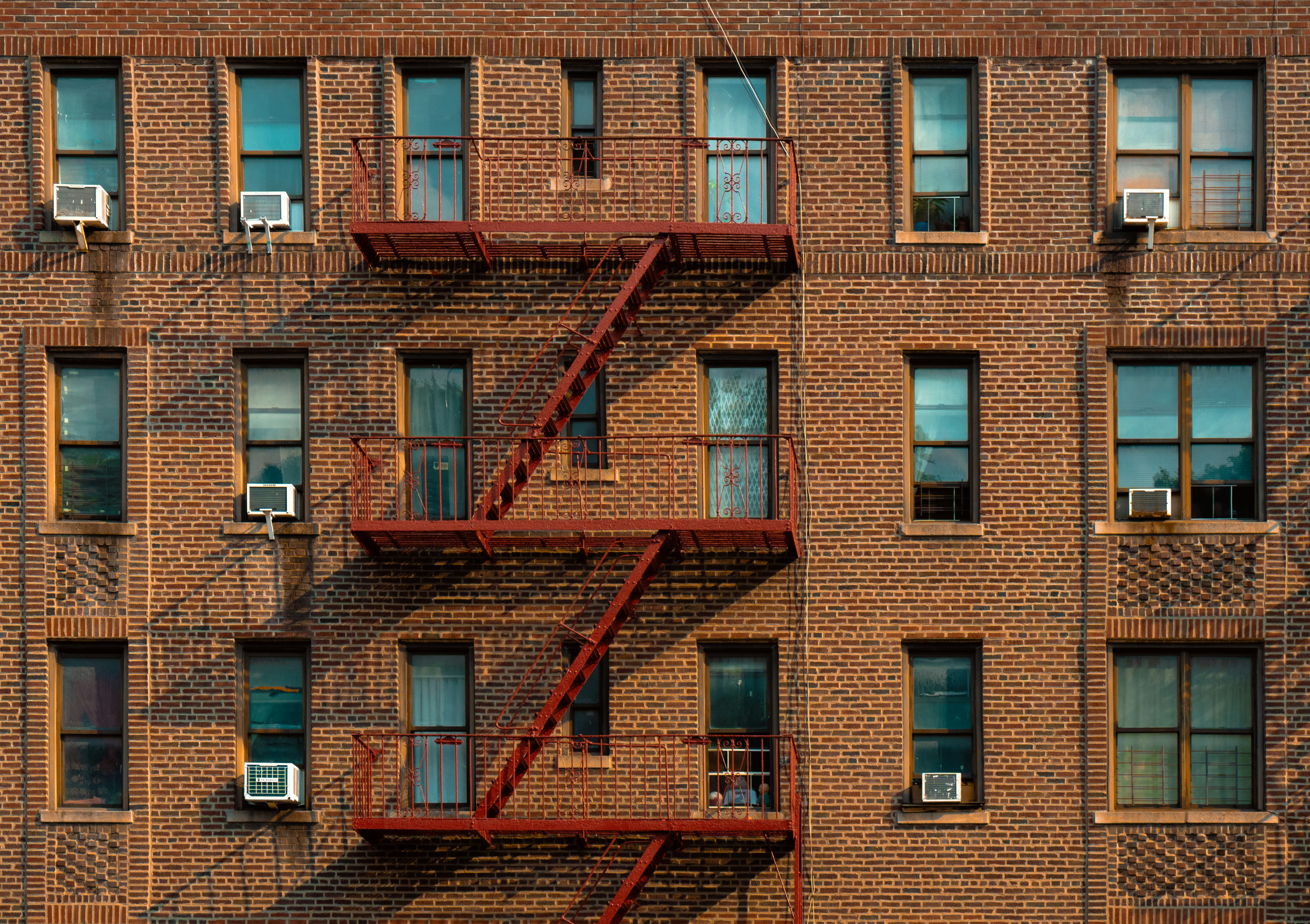 A tall brick building with a fire escape