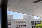 A hotel with a large white building in the background