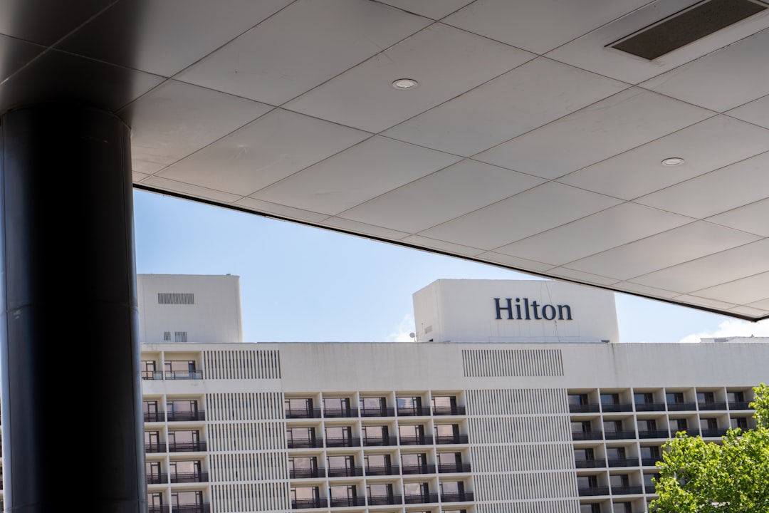 A hotel with a large white building in the background,
