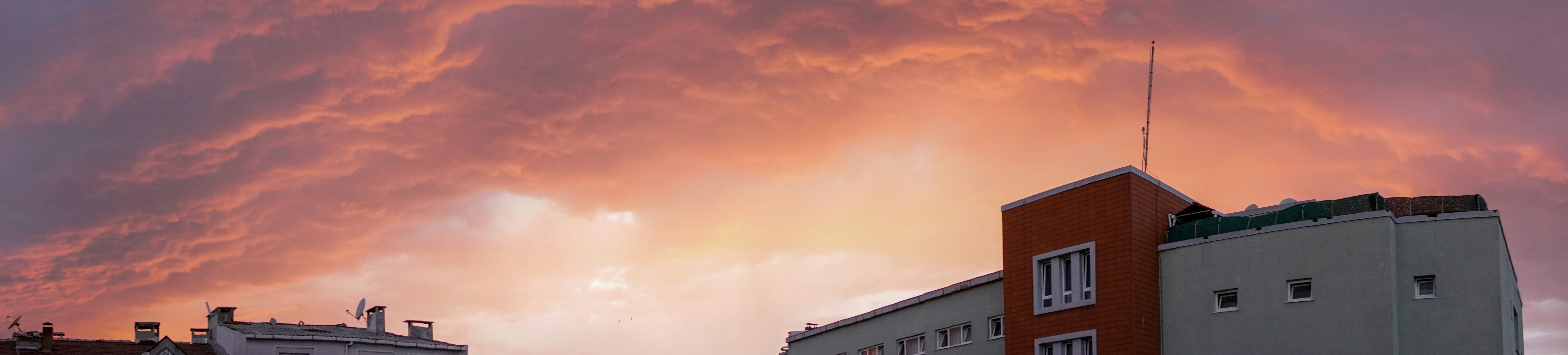 A red and white cloud is in the sky