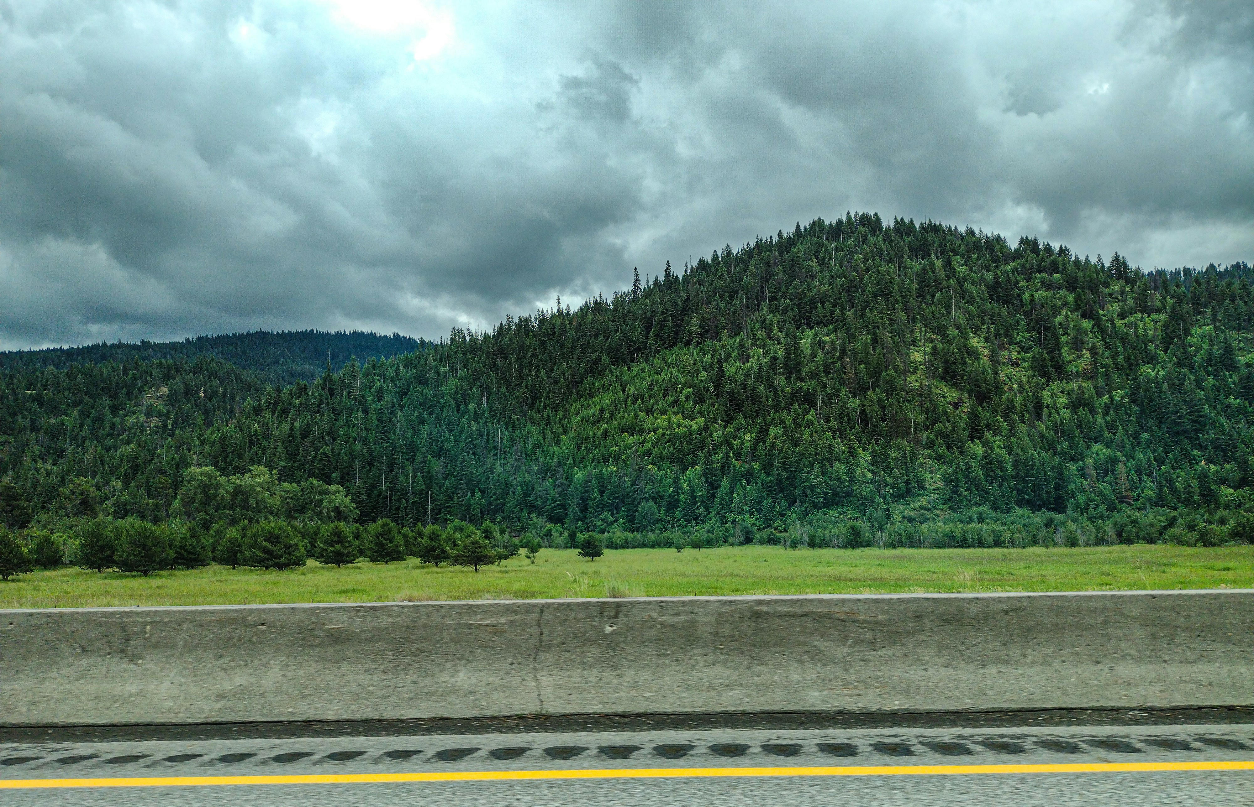 A highway with a mountain in the background