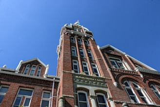 A tall brick building with a clock on it's side