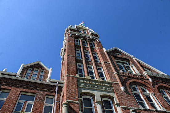A tall brick building with a clock on it's side