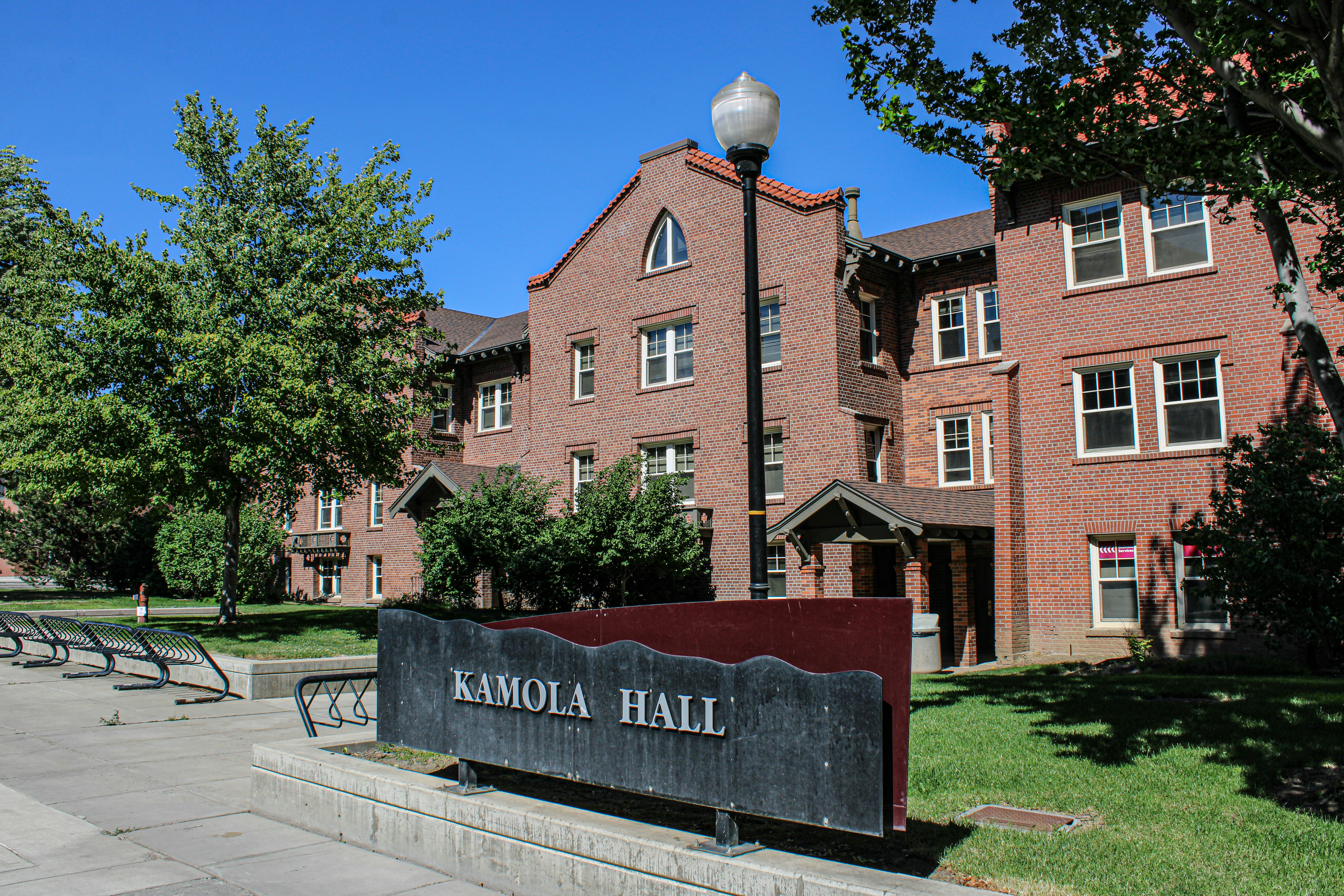 A large brick building with a sign in front of it