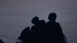 A couple of people that are standing in the snow