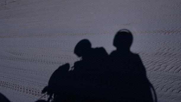 A couple of people that are standing in the snow