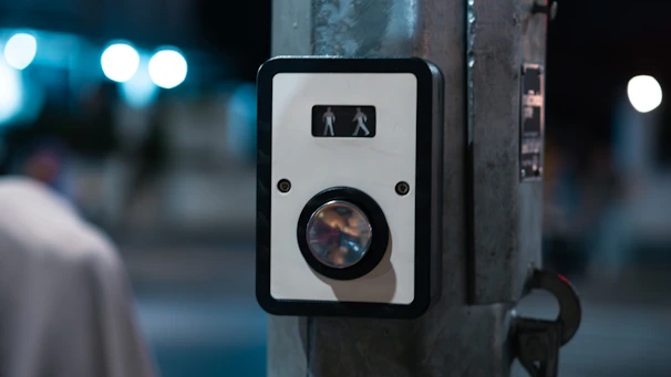 A close up of a button on a pole
