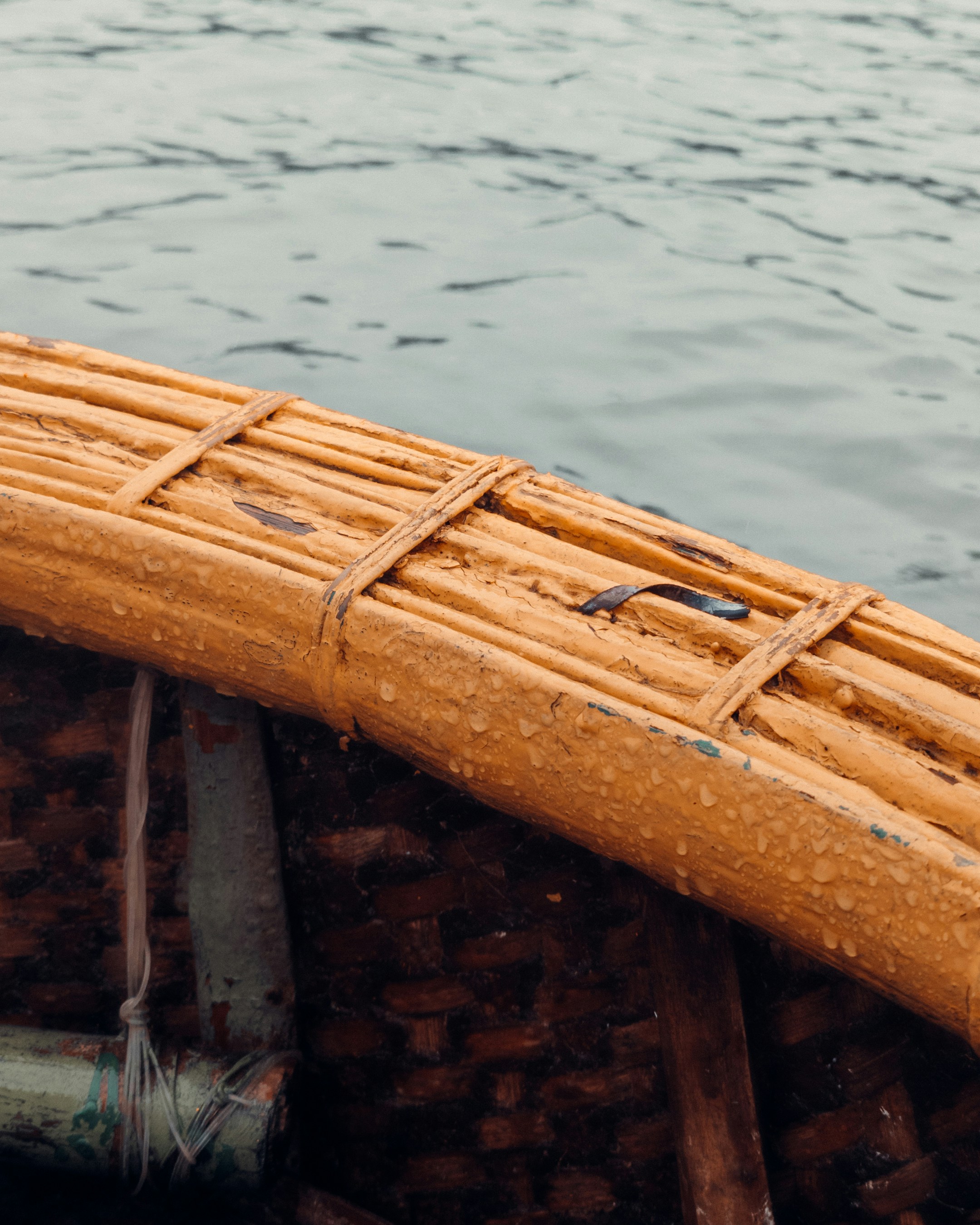 A close up of a bamboo boat on a body of water