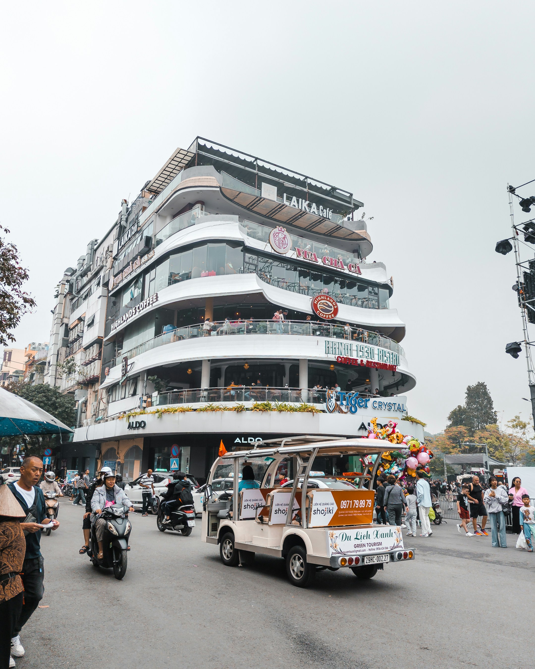 A group of people riding motorcycles down a street