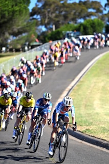 A group of people riding bikes down a road