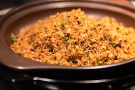 A plate of rice and peas on a stove