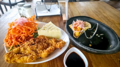 A wooden table topped with plates of food