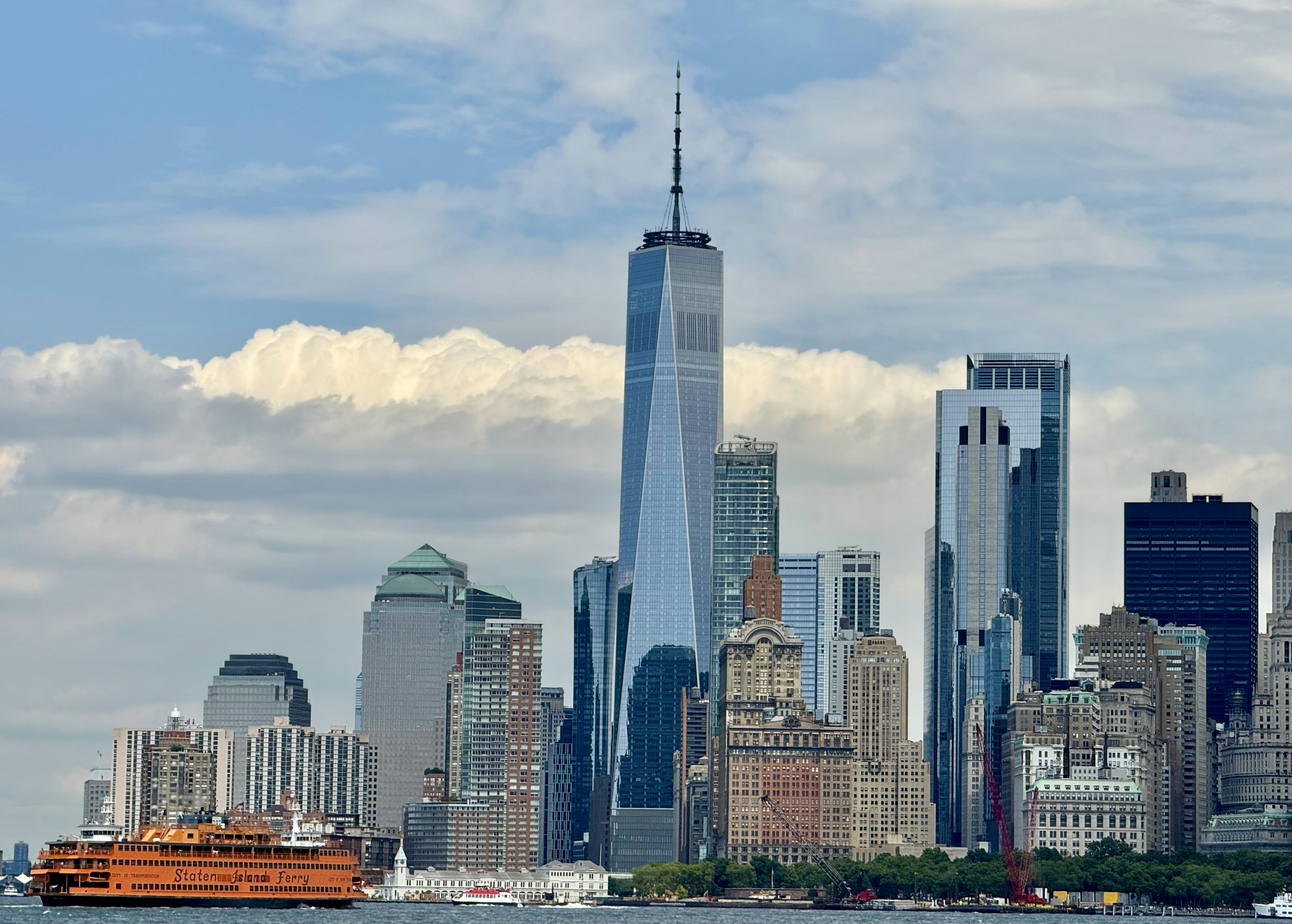 A boat is in the water in front of a large city