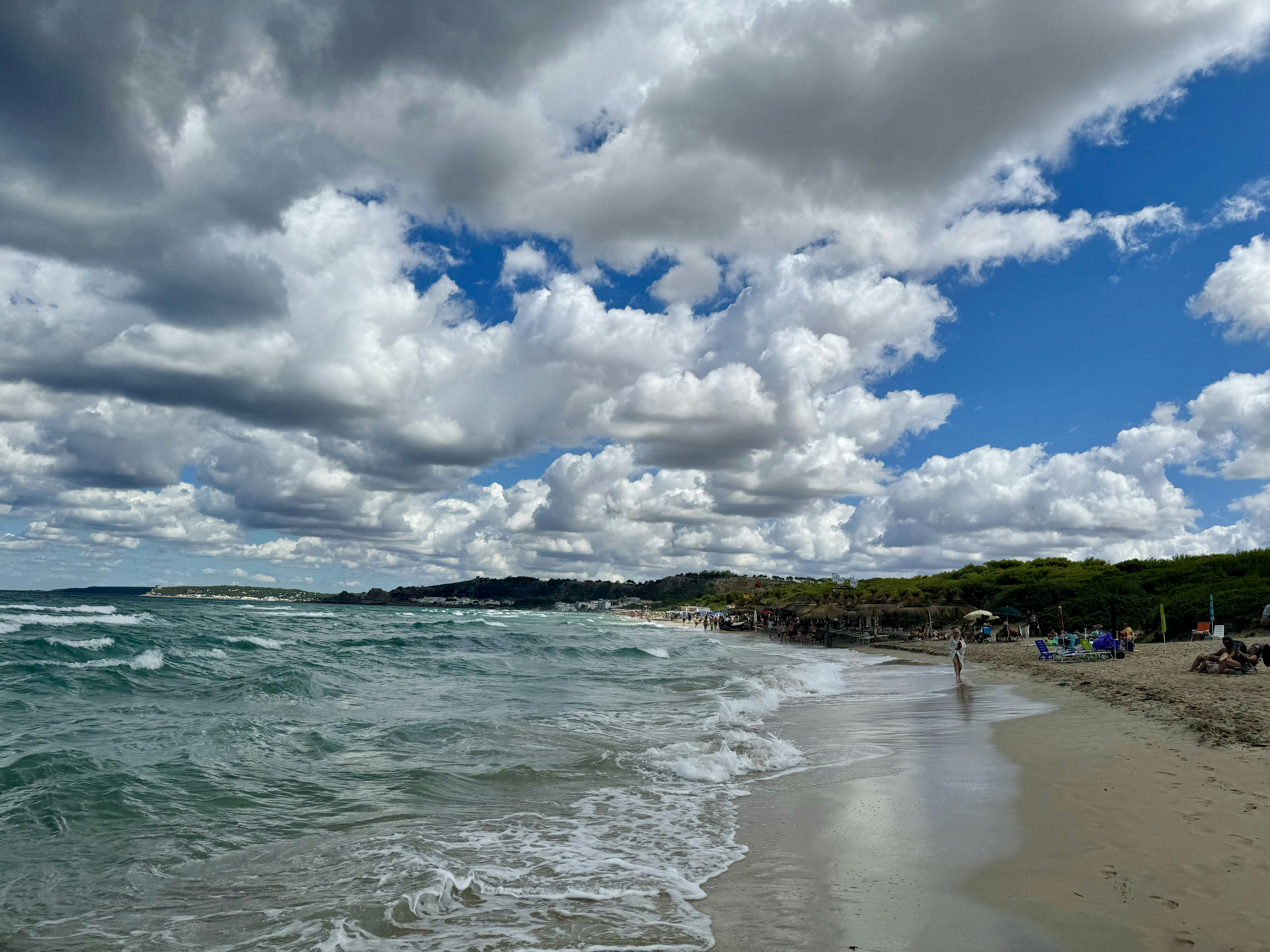 A beach that has a lot of clouds in the sky