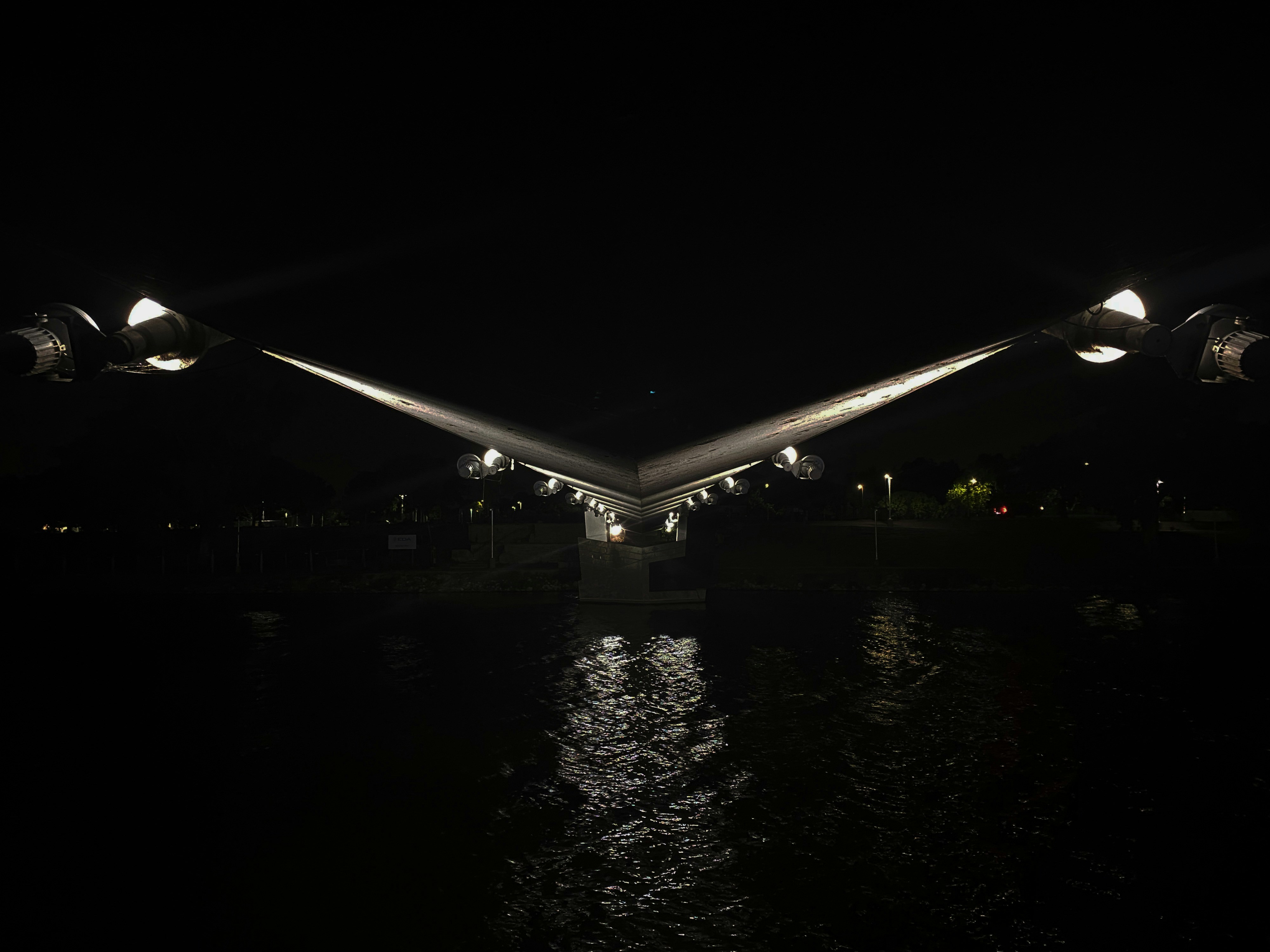 A bridge over a body of water at night, 