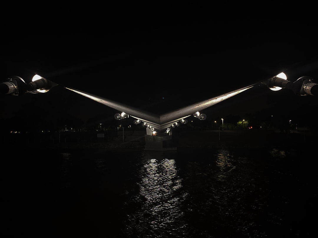 A bridge over a body of water at night,