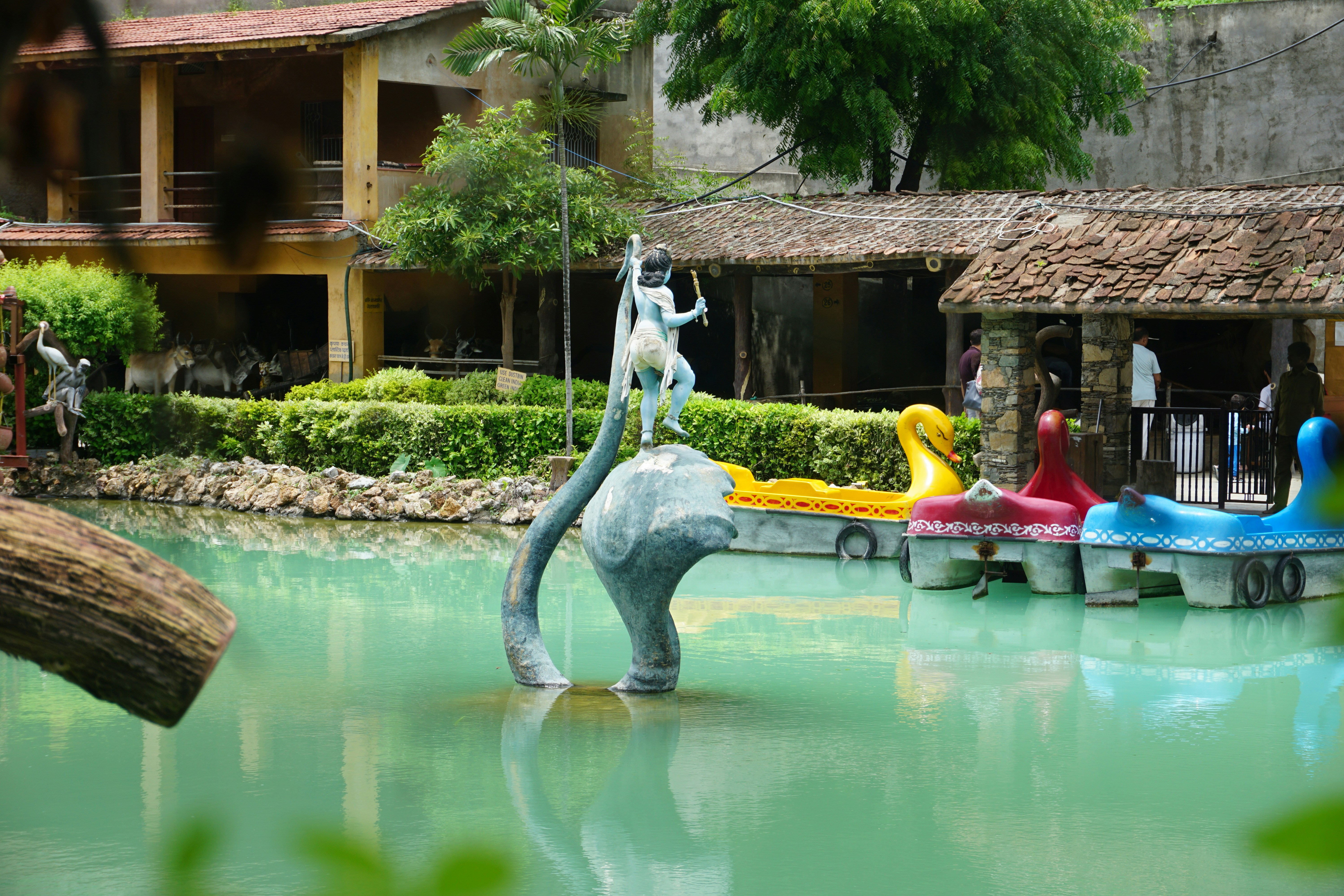 A group of people riding on top of an elephant in a body of water