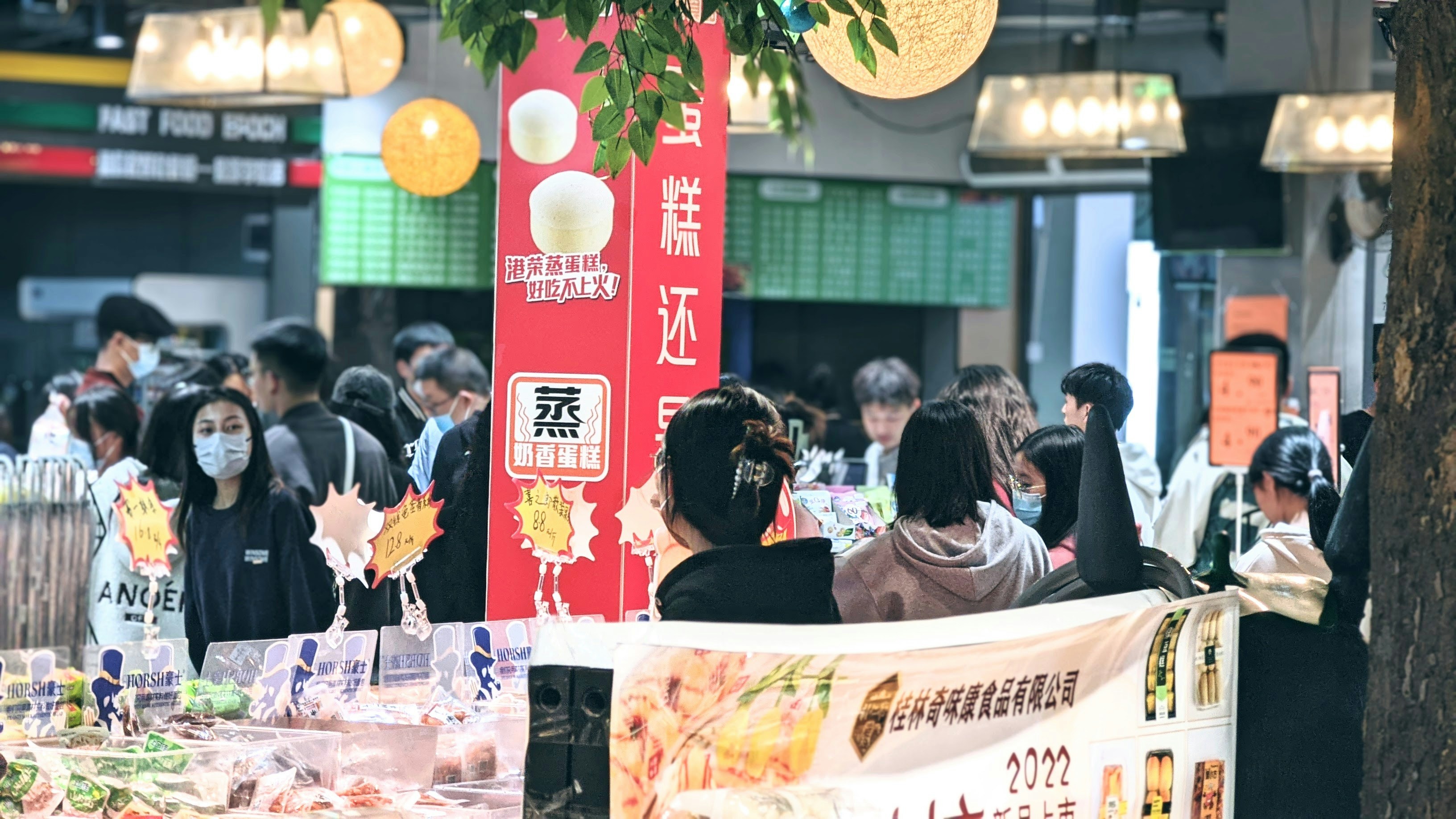 A group of people standing around a table
