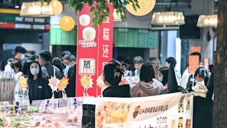 A group of people standing around a table