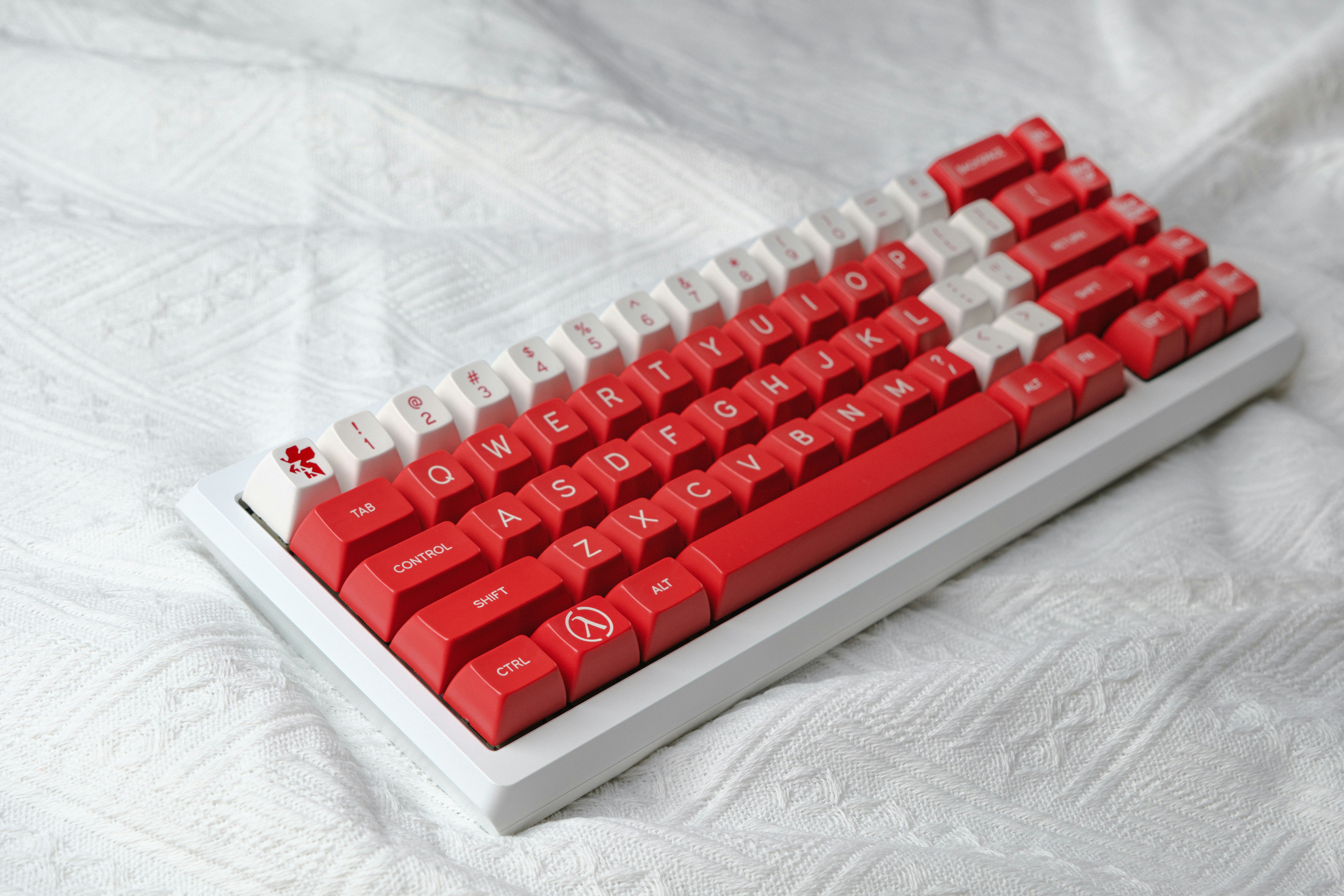 A red and white keyboard on a white sheet