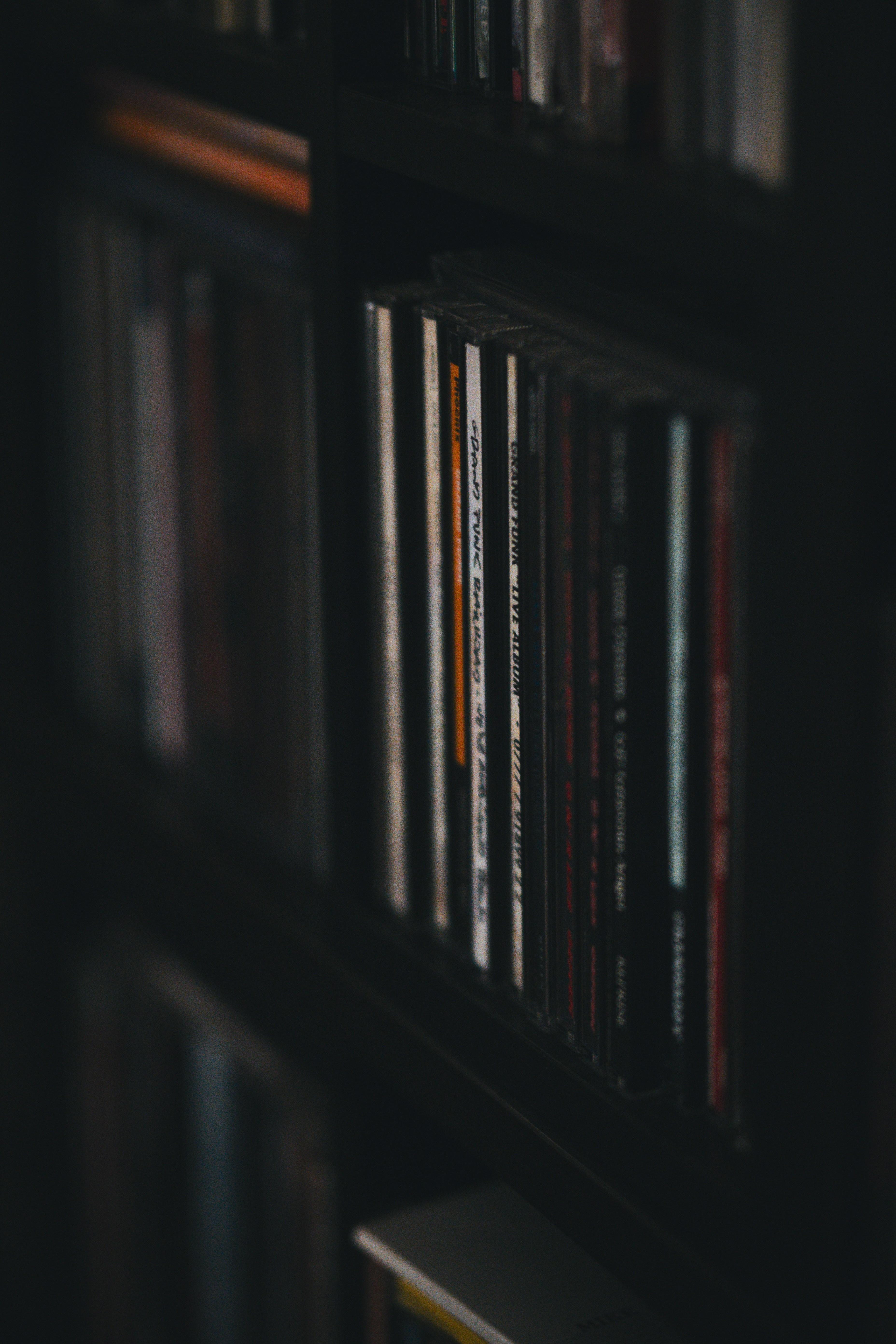 A bookshelf filled with lots of books in a dark room