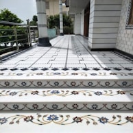 A set of white stairs with blue and gold designs