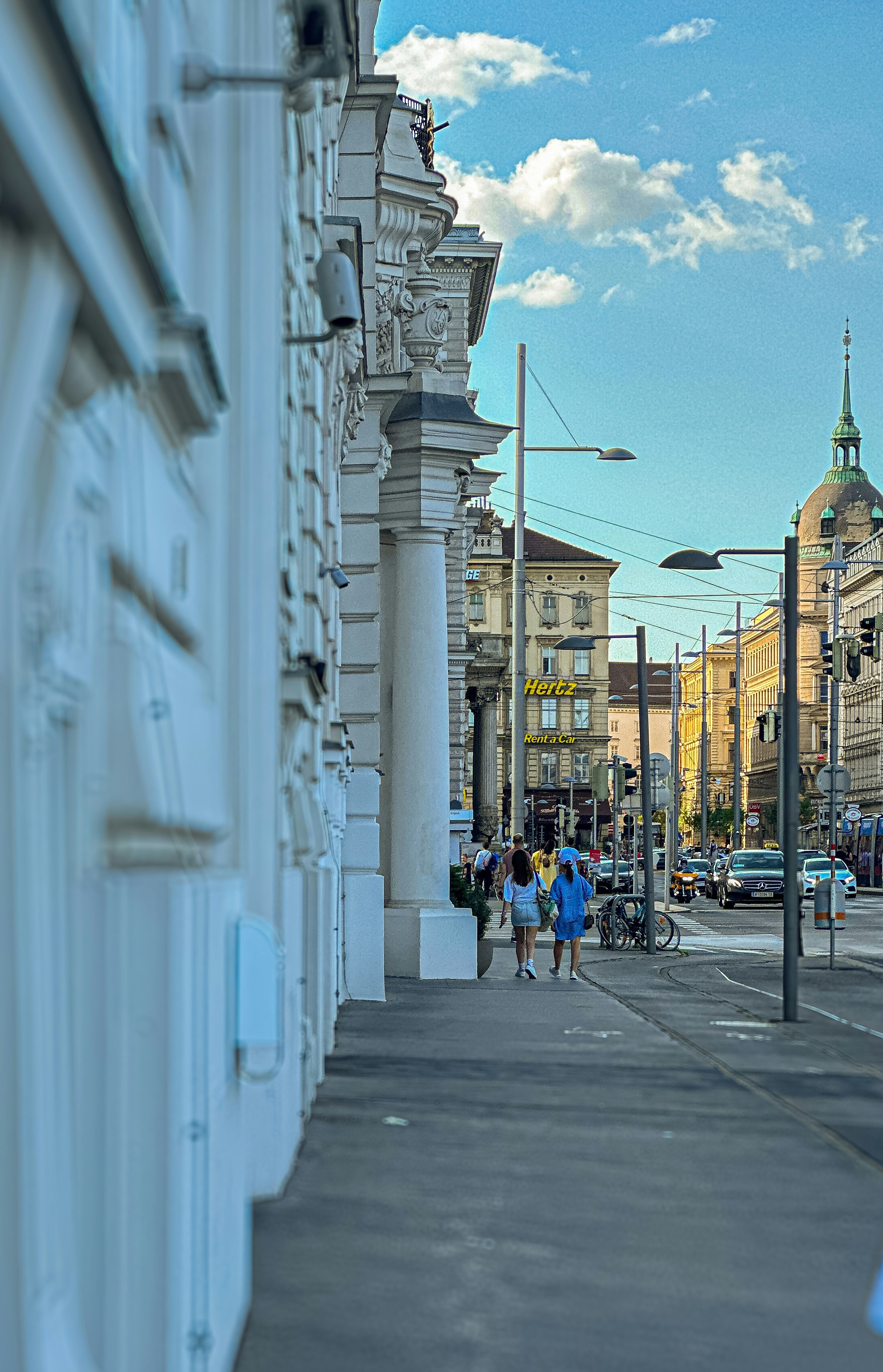 People walking down a street next to tall buildings