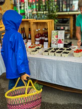 Two people standing at a table with a basket of food