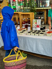 Two people standing at a table with a basket of food