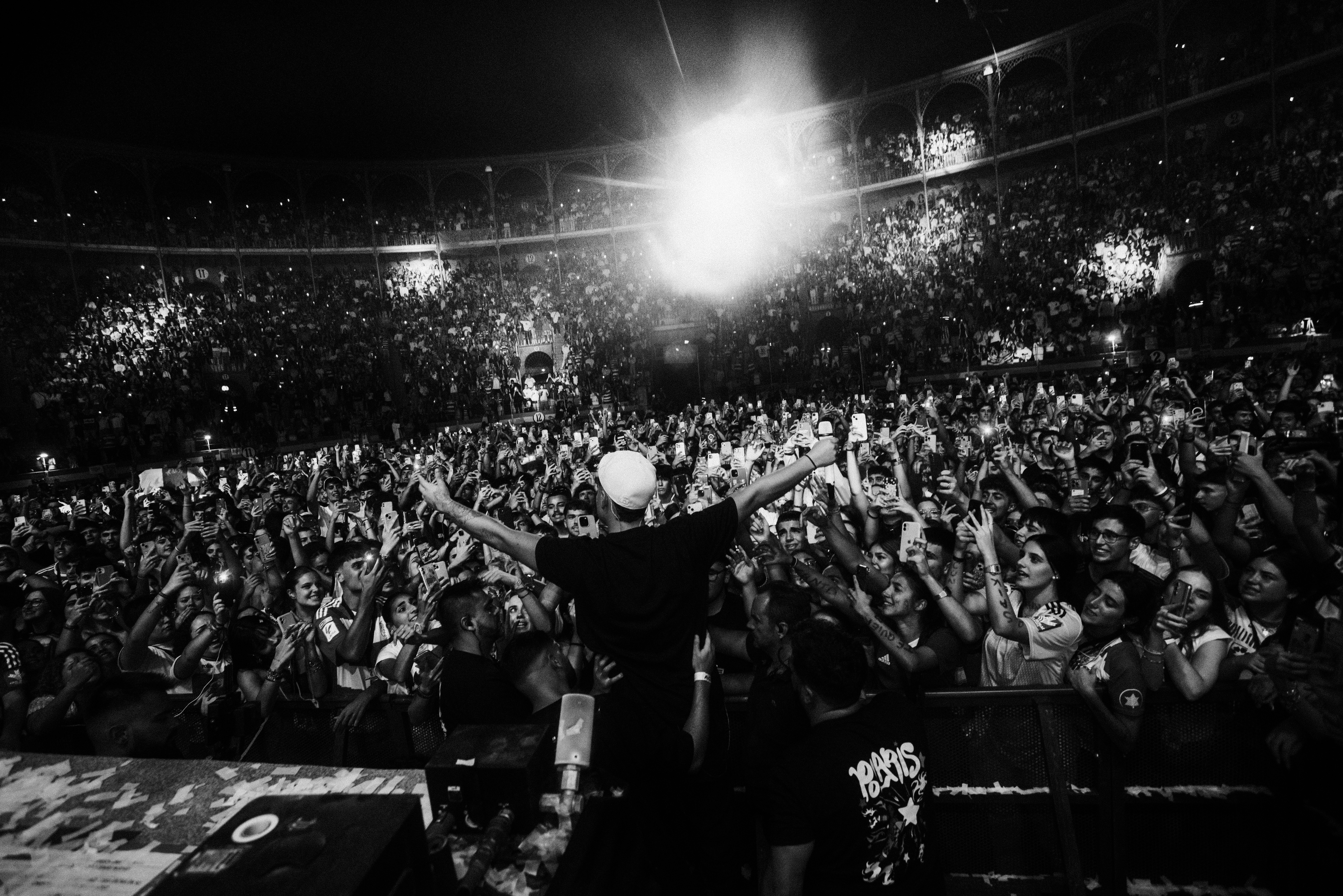 A man standing on top of a stage in front of a crowd
