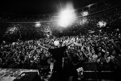 A man standing on top of a stage in front of a crowd