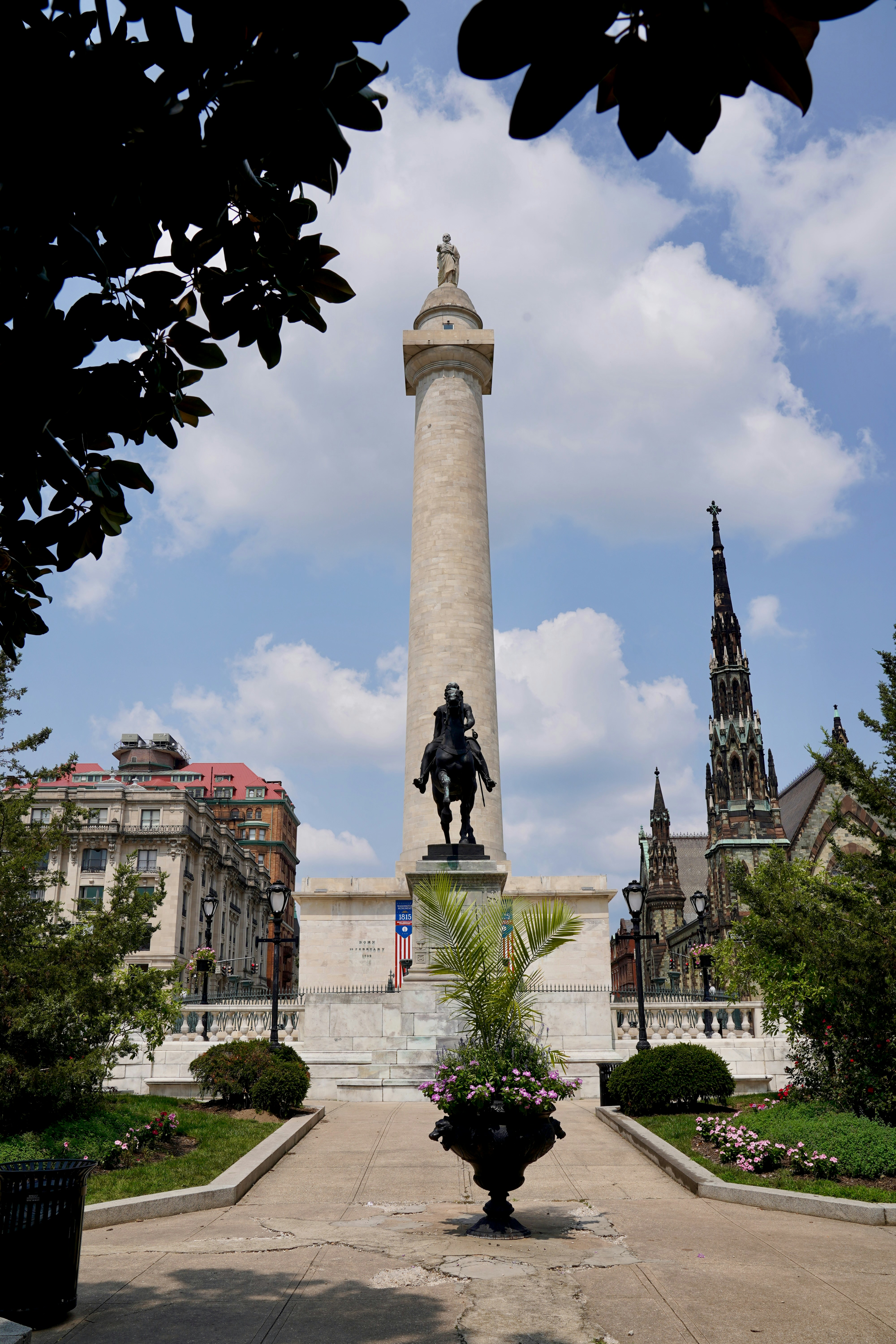 A statue of a man is in the middle of a courtyard