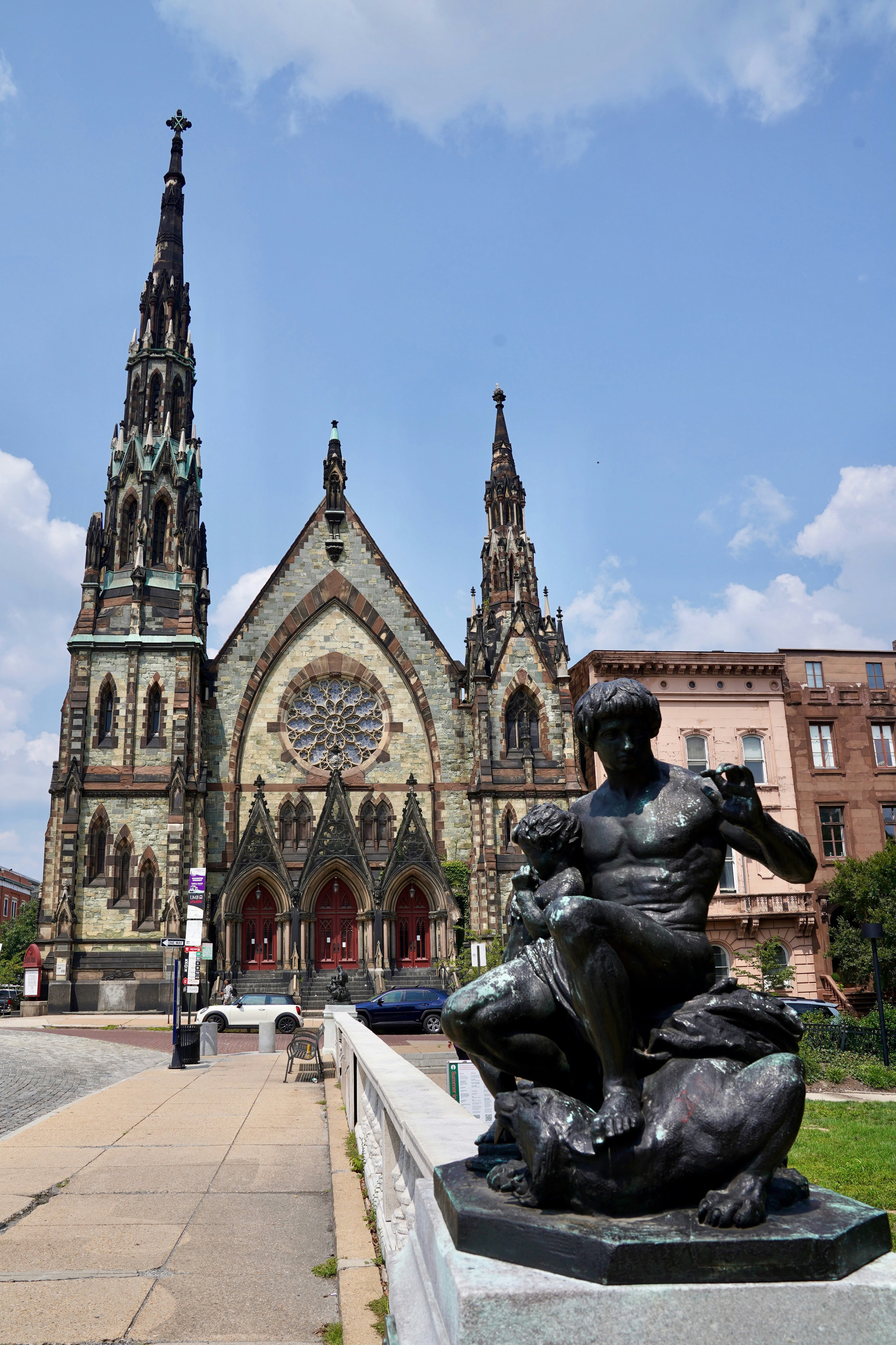 A statue of a woman sitting in front of a church