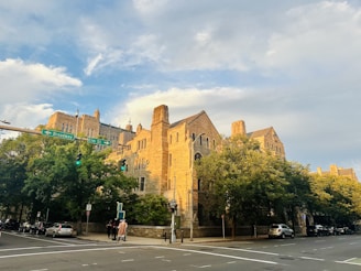 A street corner with a large building in the background