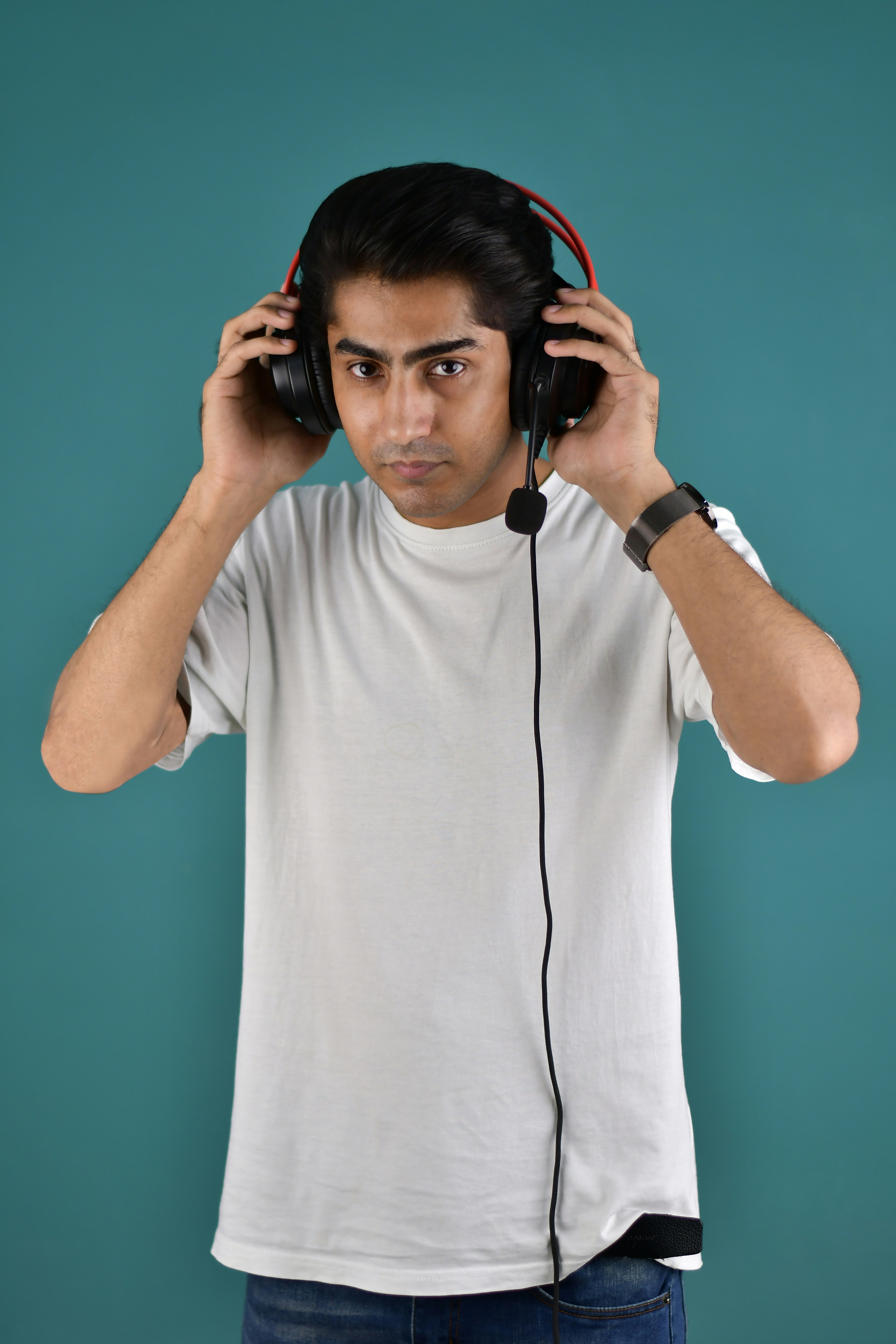 A man wearing headphones and a white t - shirt