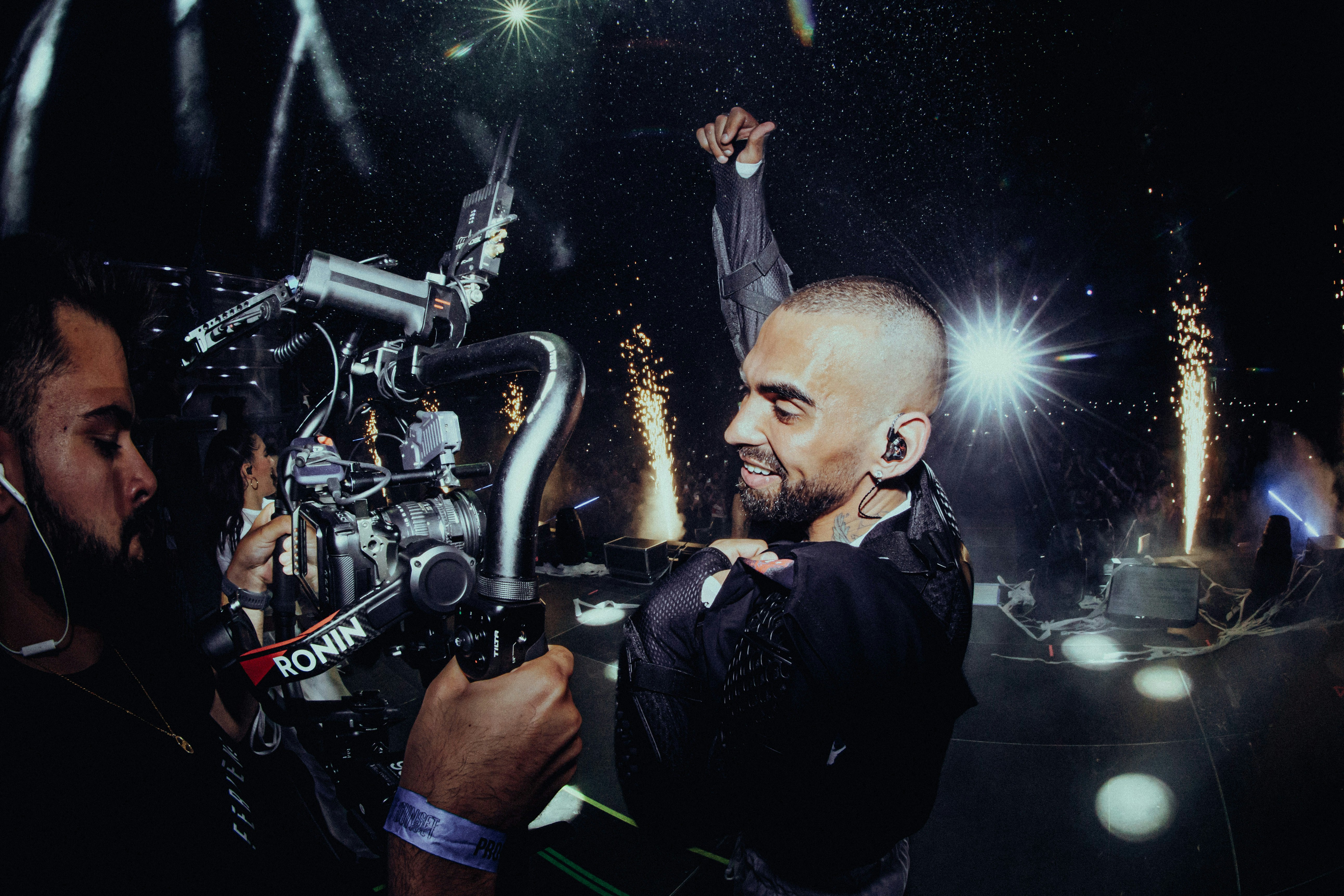 A man holding a camera in front of a crowd of people