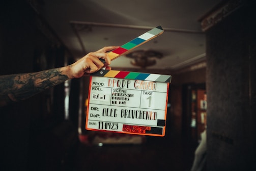 A person holding a clapper in their hand
