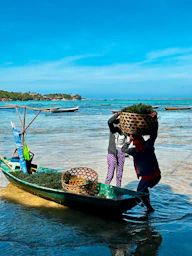 A person on a small boat with a lot of stuff on it