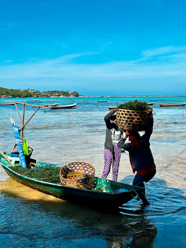 A person on a small boat with a lot of stuff on it