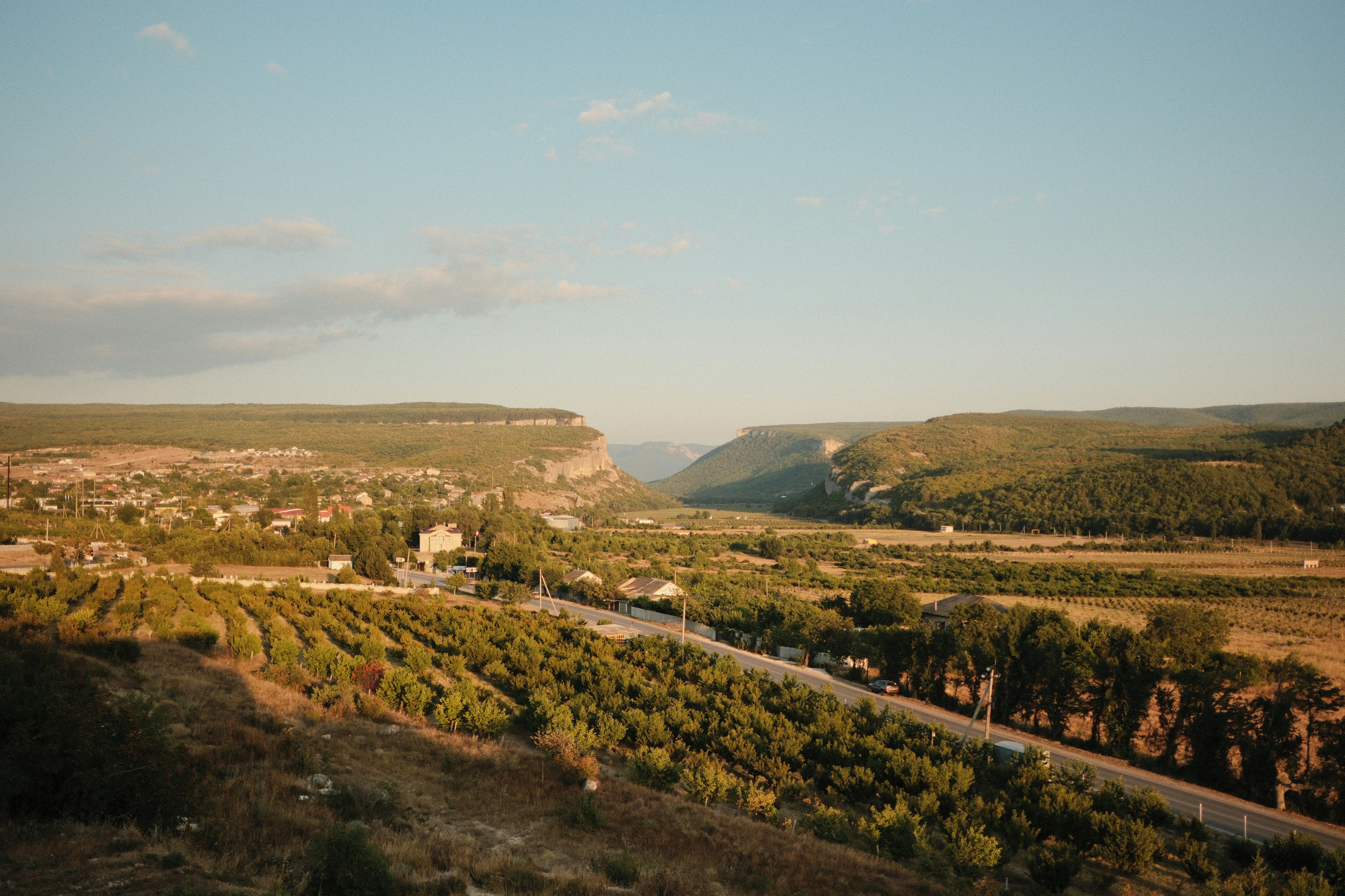 A scenic view of a valley and a road