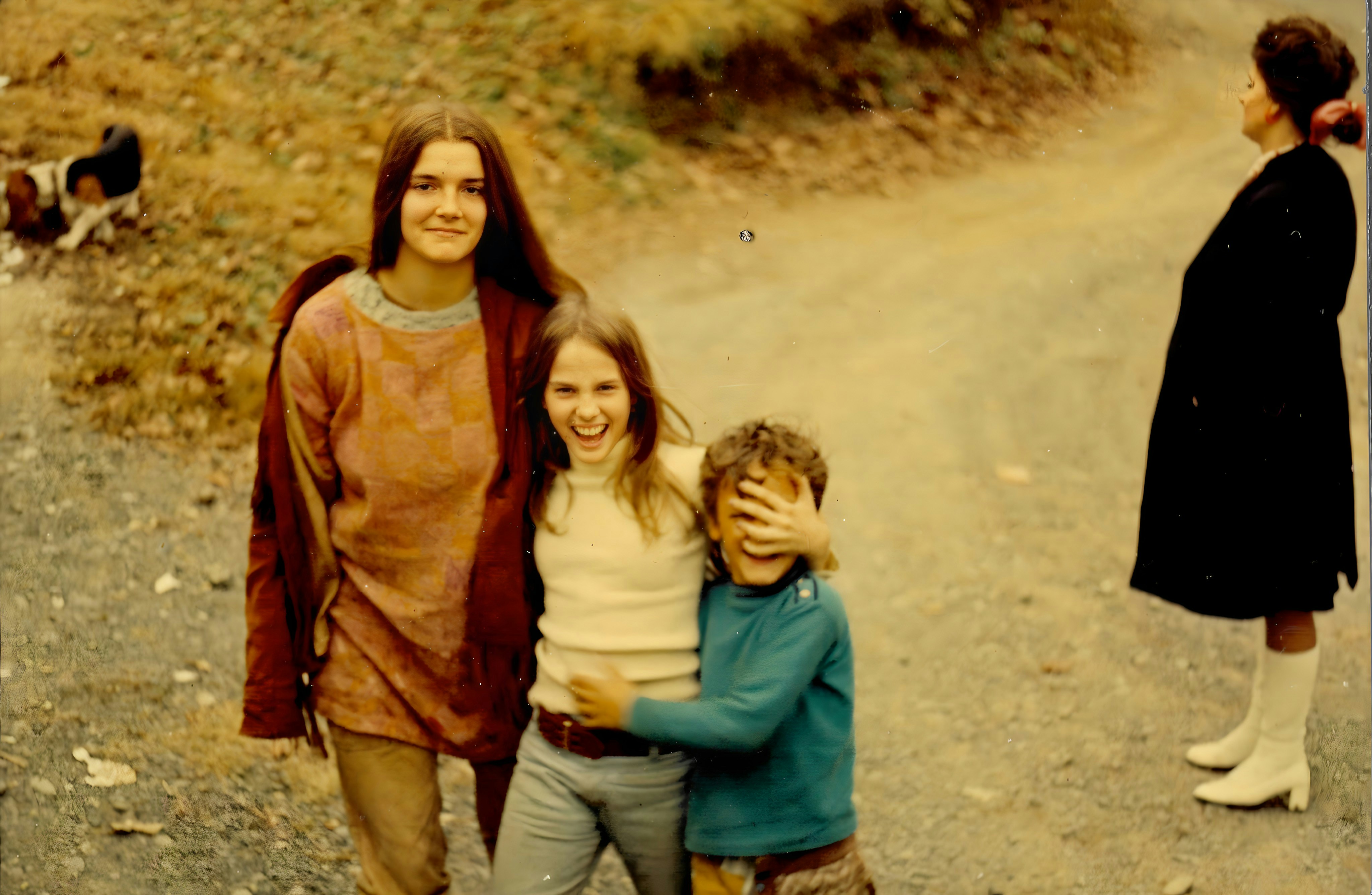 A group of people walking down a dirt road