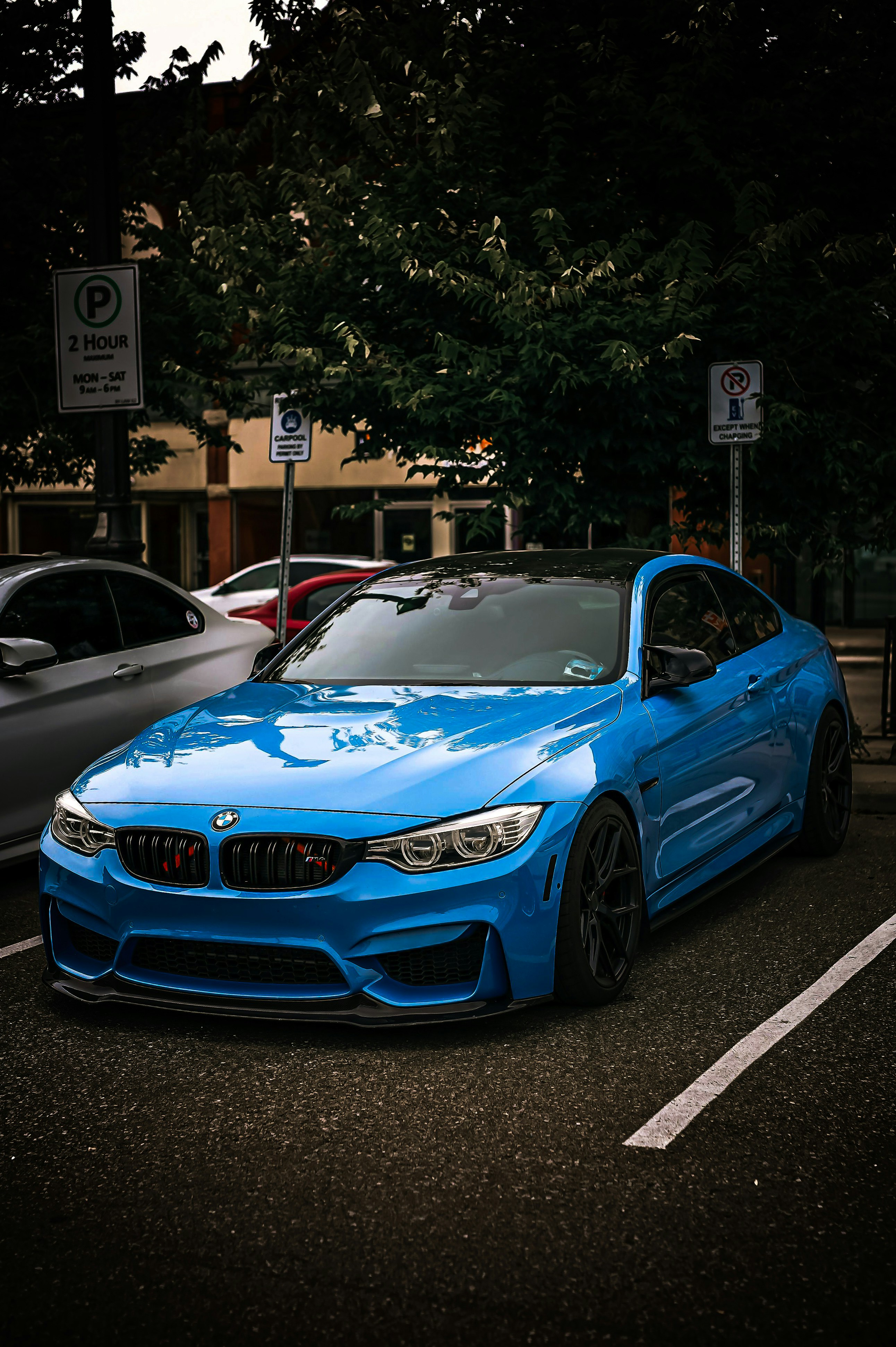 A blue car parked in a parking lot