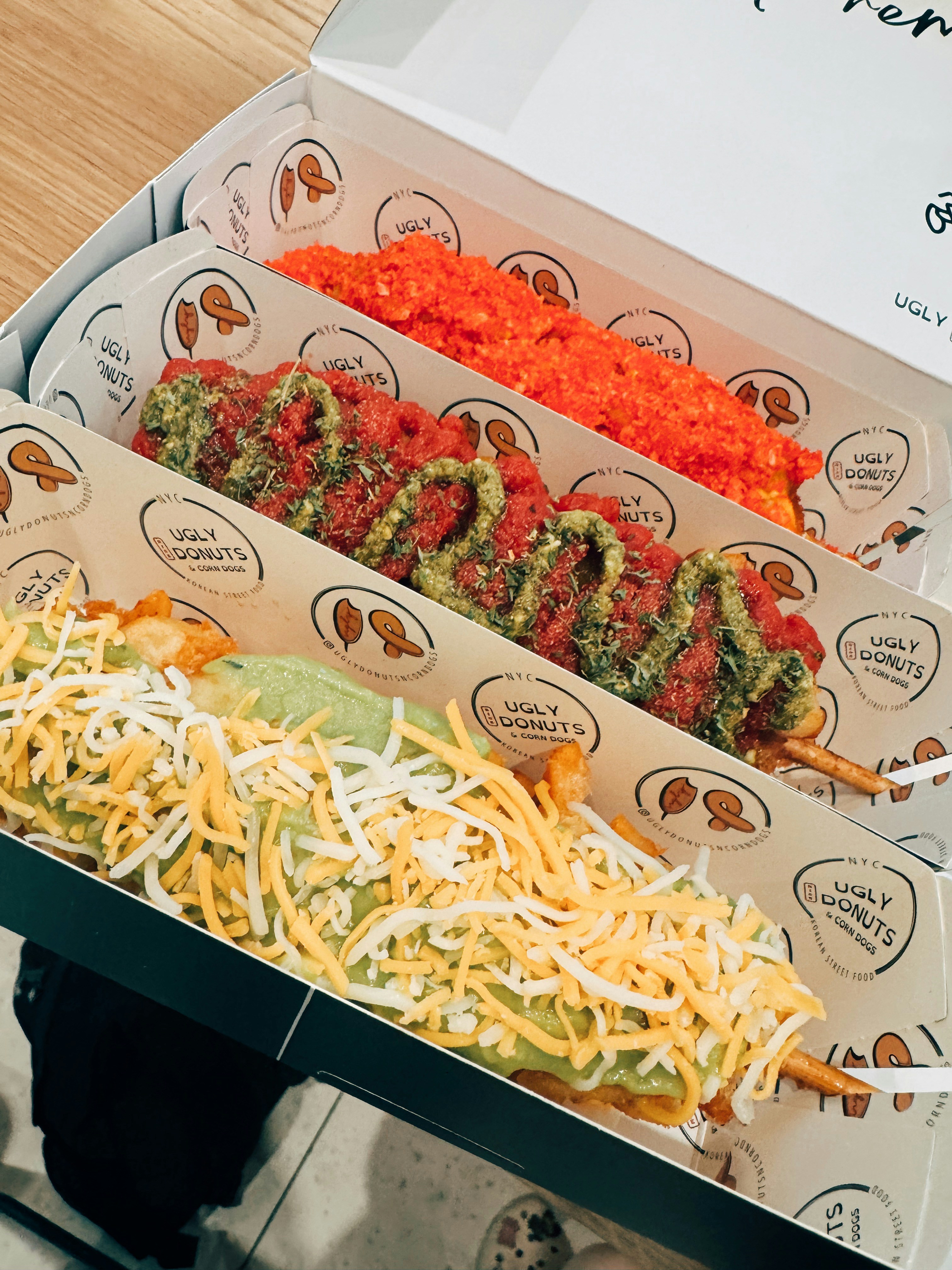 A couple of hot dogs in a box on a table