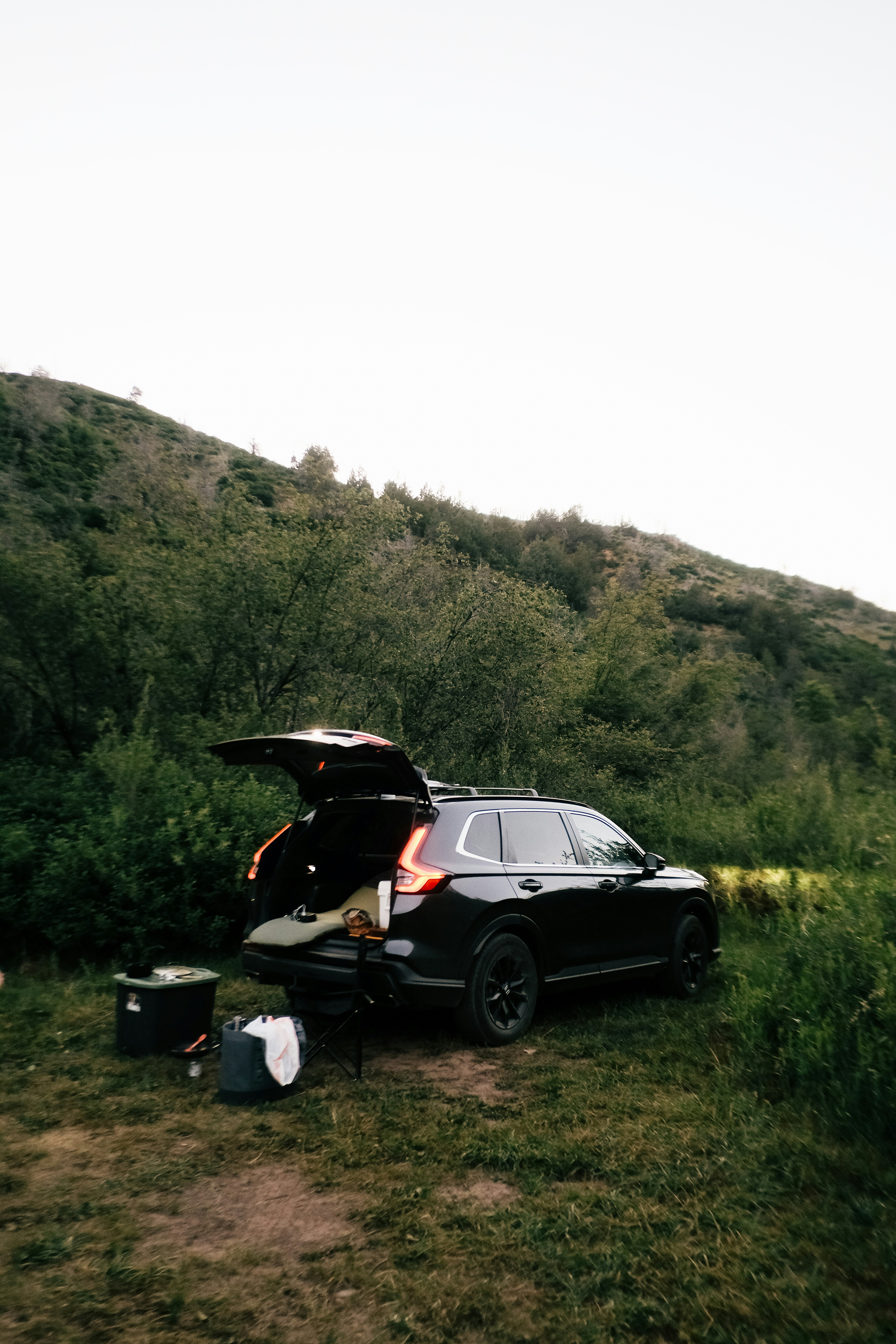 A car is parked on the side of a hill