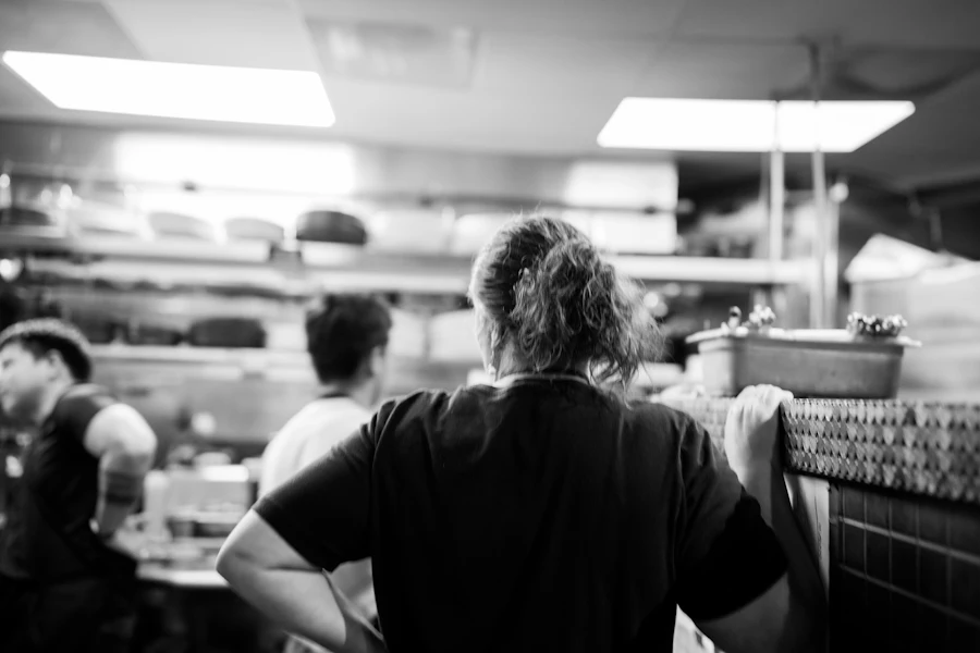 Team of cooks preparing food together in a commercial kitchen