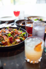 A table topped with plates of food and drinks