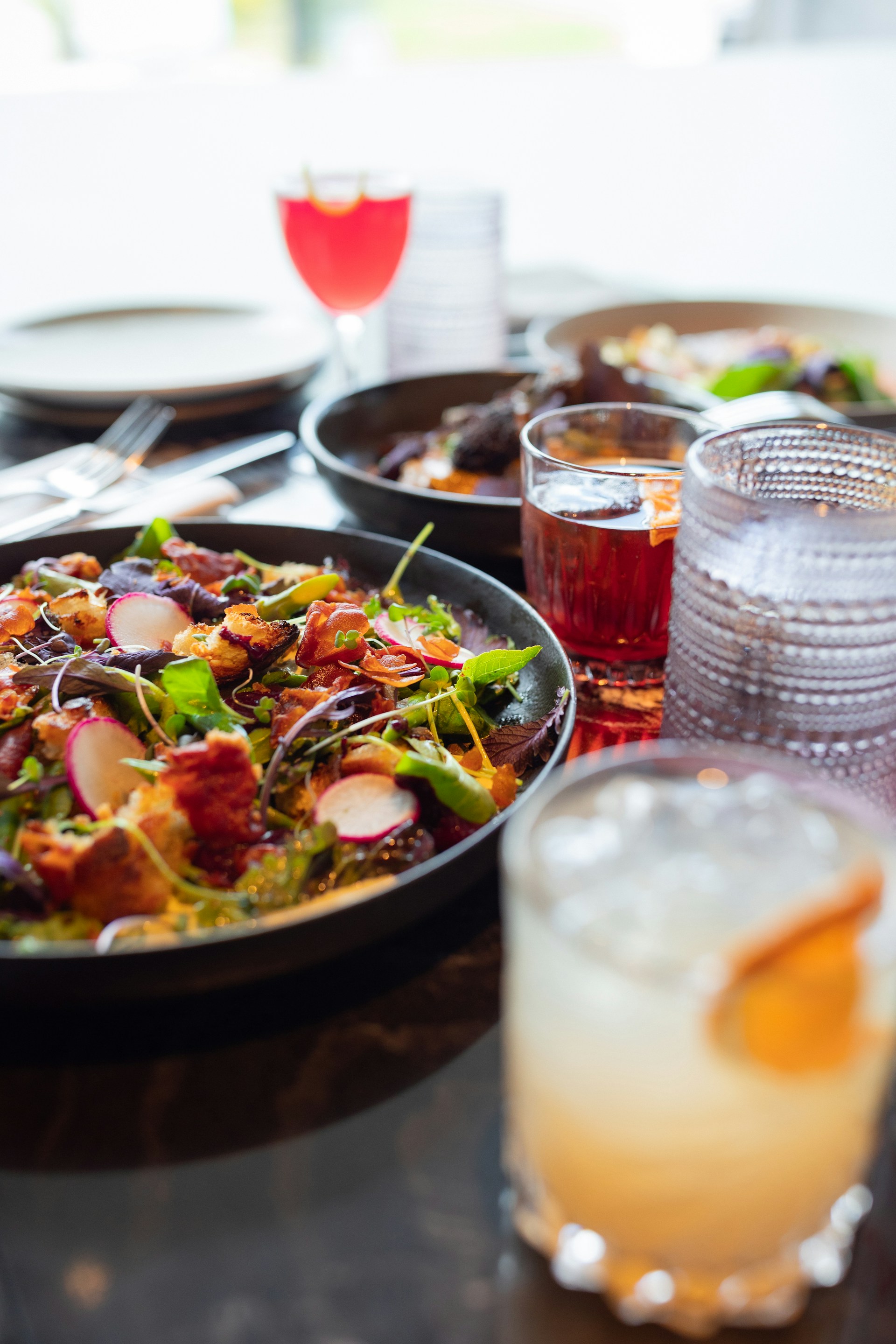 A table topped with plates of food and drinks