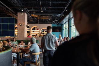 A group of people sitting at tables in a restaurant