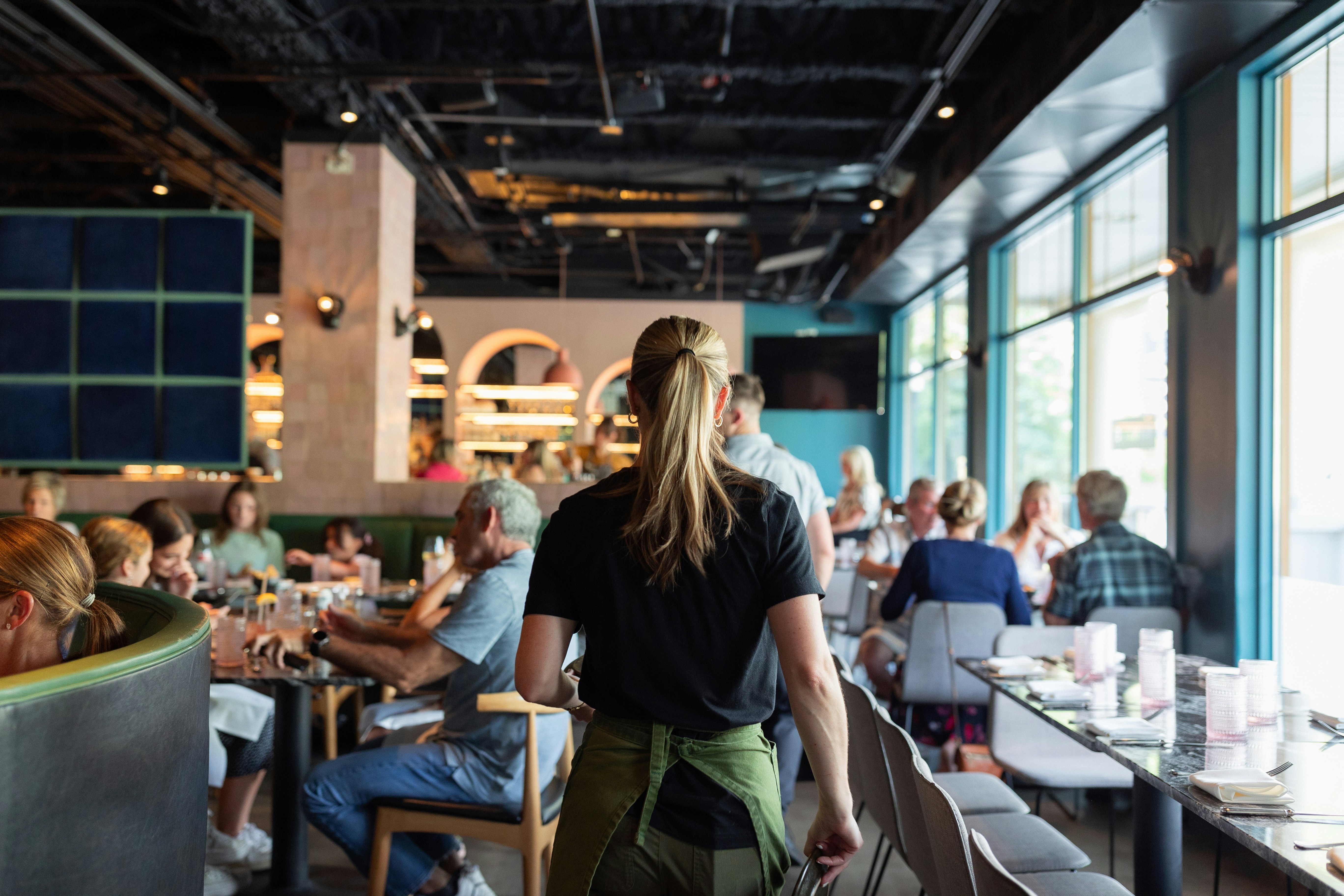 A group of people sitting at tables in a restaurant